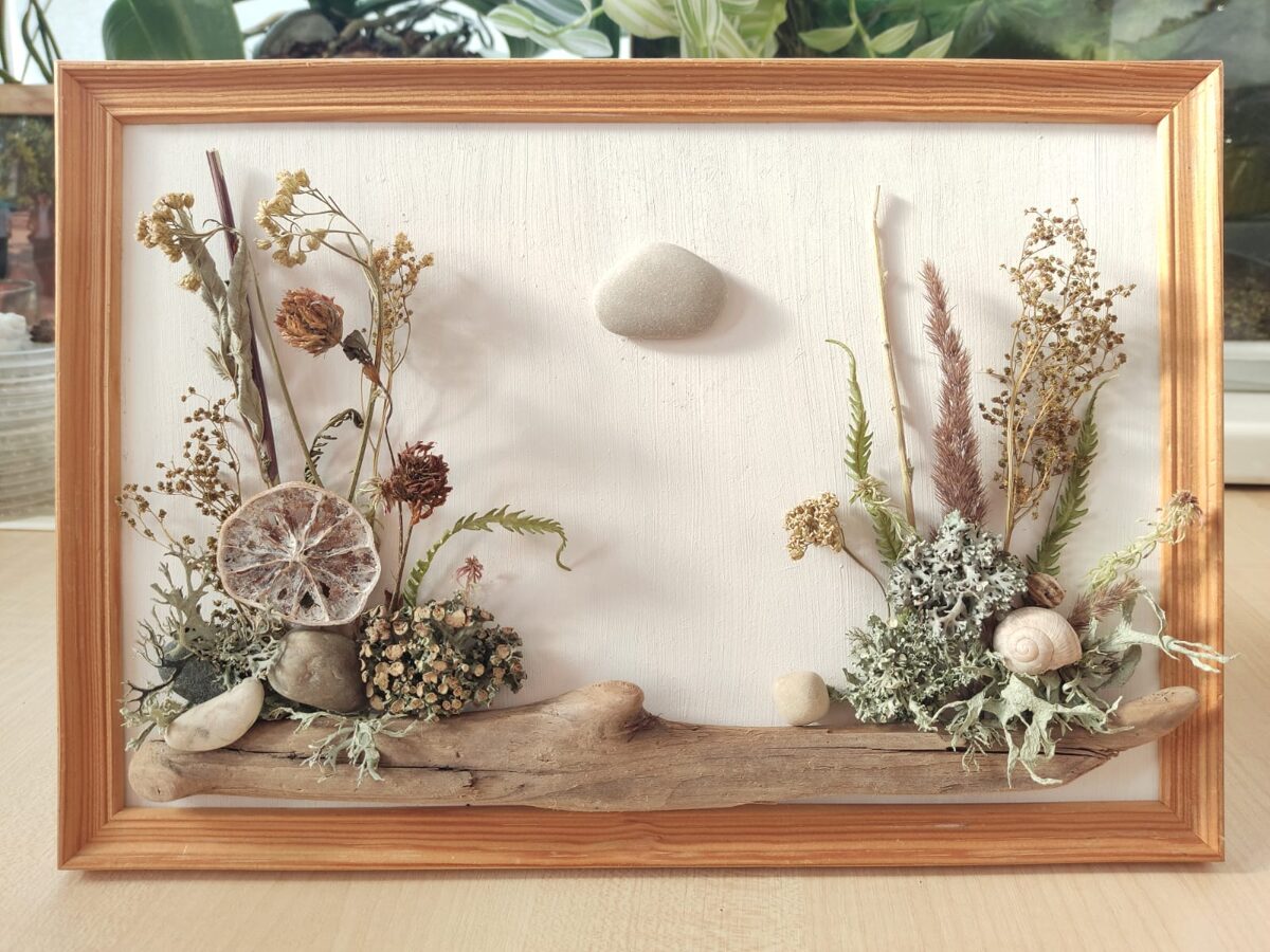 Nature-based wall artwork made from natural materials arranged on a painted base